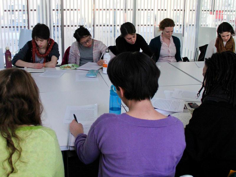 A group of students in a classroom taking notes on a reading